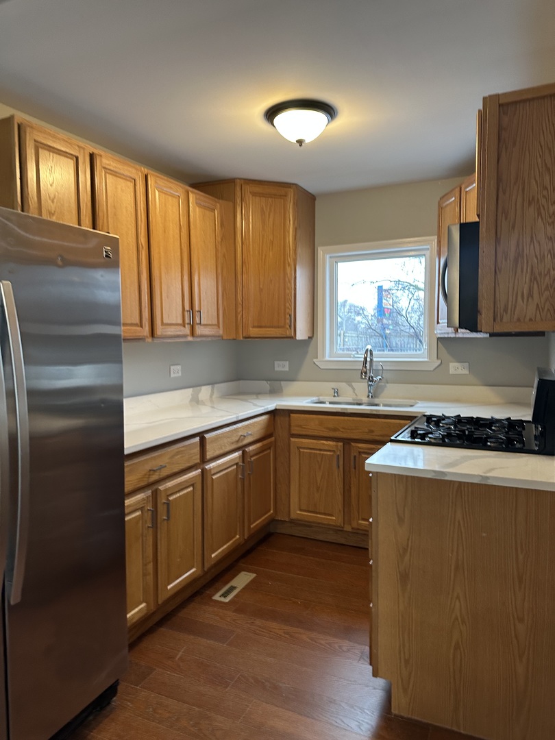 905 Tomahawk Trail Round Lake Heights, IL 60073 - Photo 5 of 15 a kitchen with granite countertop cabinets stainless steel appliances a sink and a window