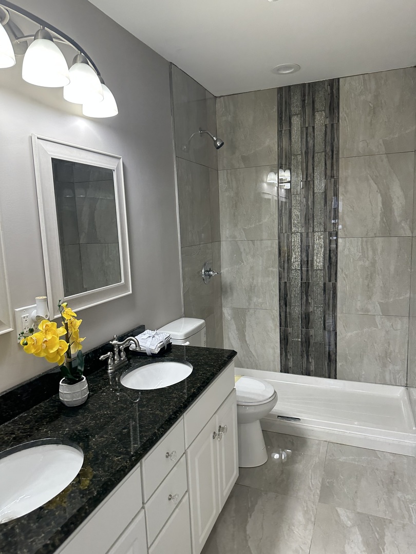 905 Tomahawk Trail Round Lake Heights, IL 60073 - Photo 7 of 15 a bathroom with a granite countertop sink toilet and shower