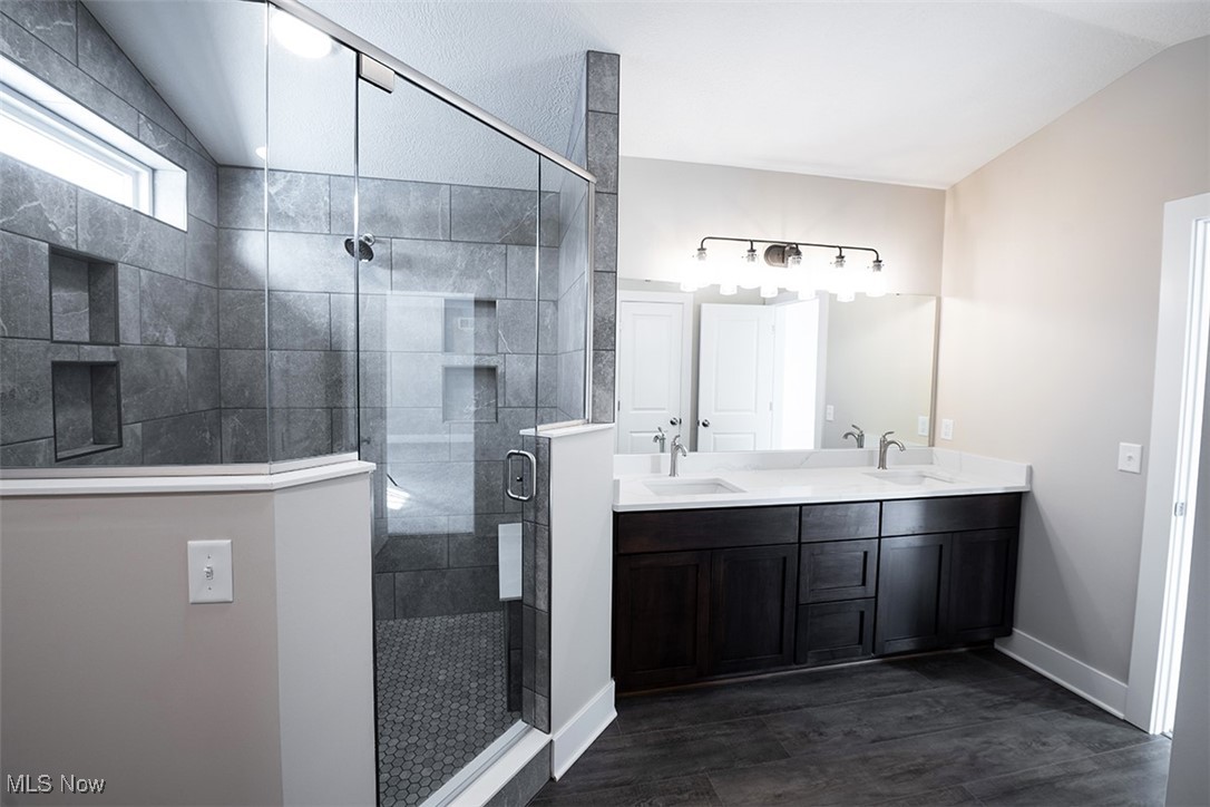 6960 State Road Wadsworth, OH 44281 - Photo 32 of 45 Bathroom featuring hardwood / wood-style floors, vanity, a shower with door, and vaulted ceiling