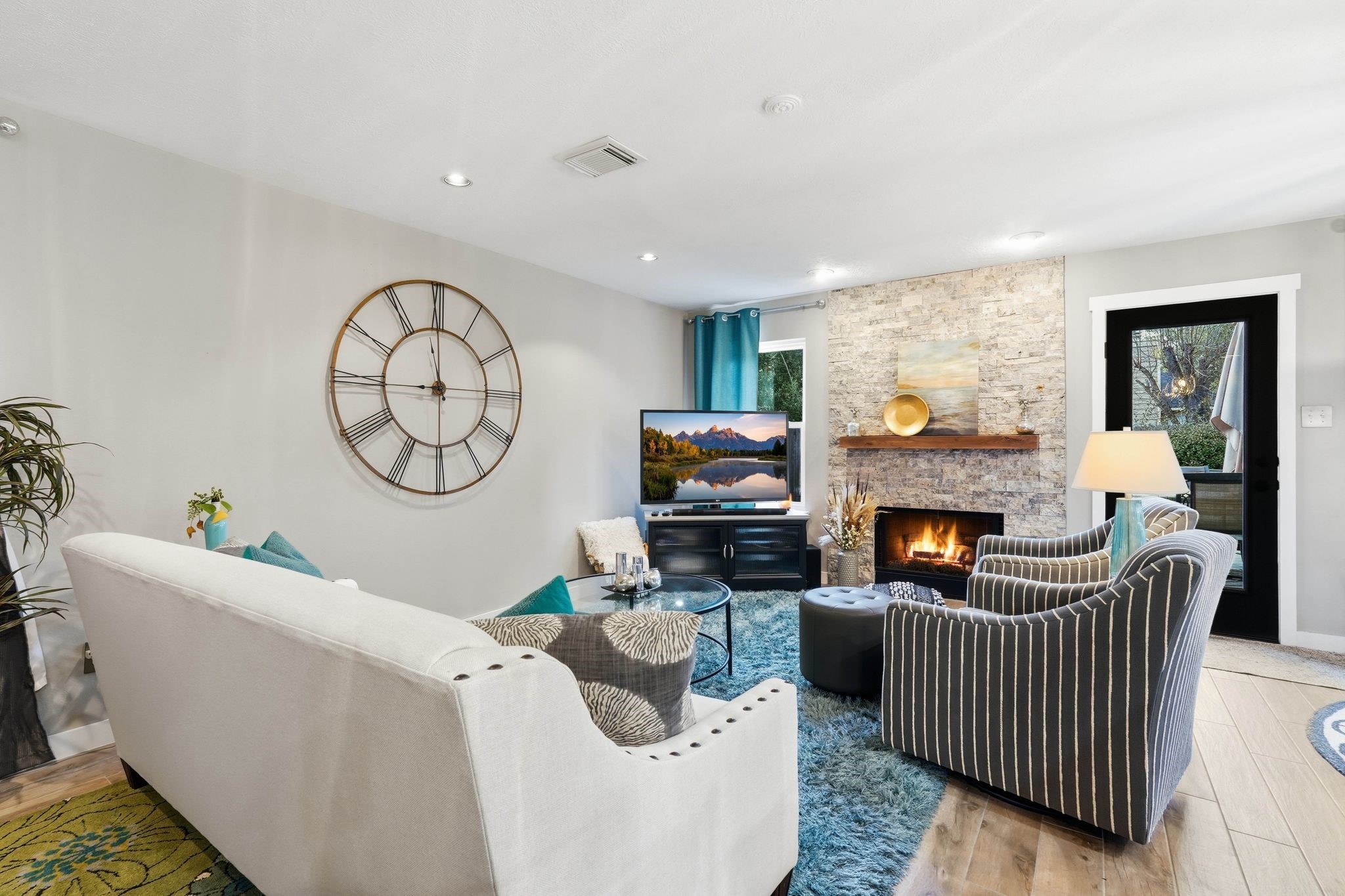 51 Wineberry Place Spring, TX 77382 - Photo 16 of 45 a living room with furniture a rug a fireplace and a large window