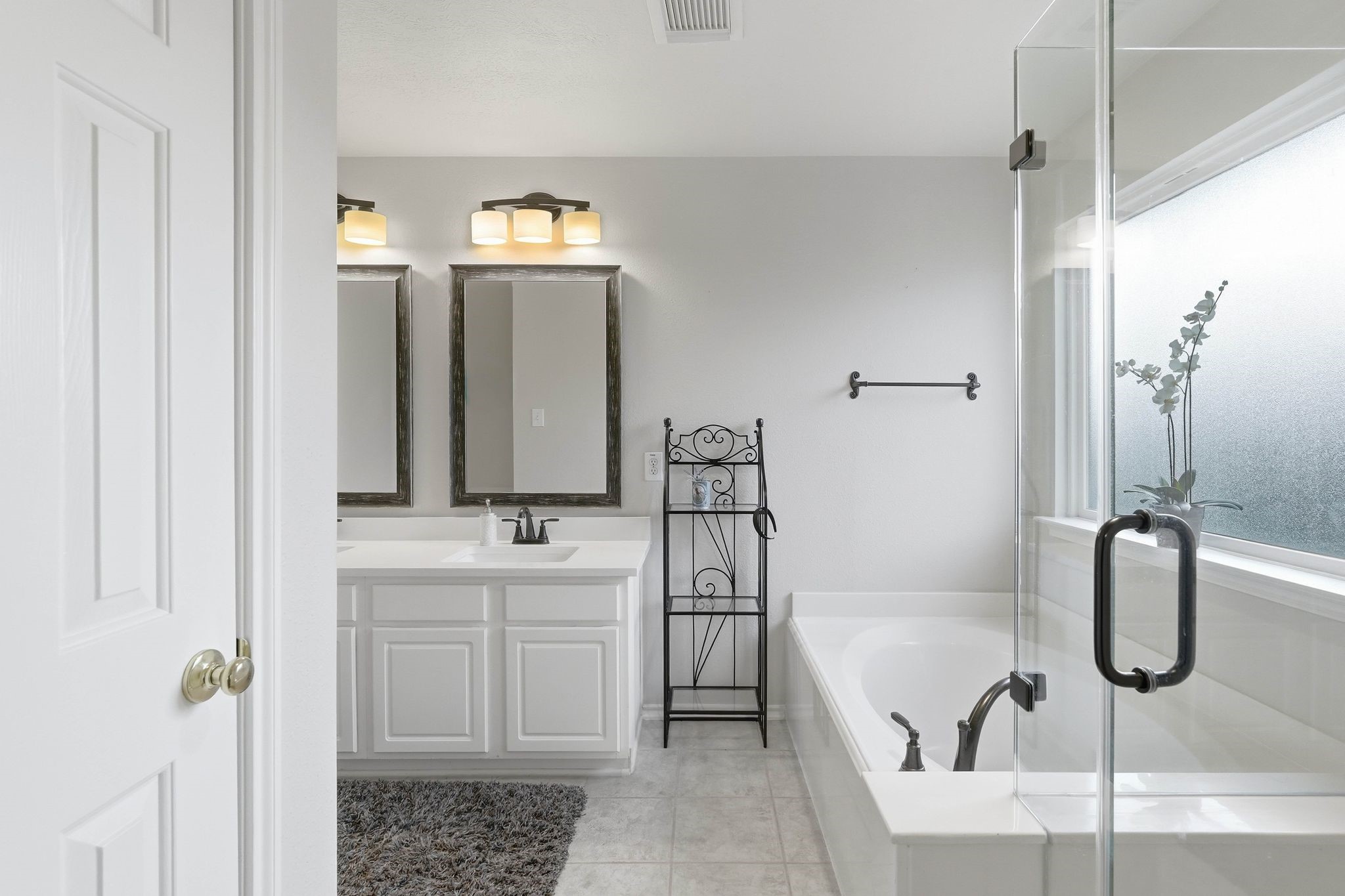 51 Wineberry Place Spring, TX 77382 - Photo 24 of 45 a bathroom with a tub sink and mirror