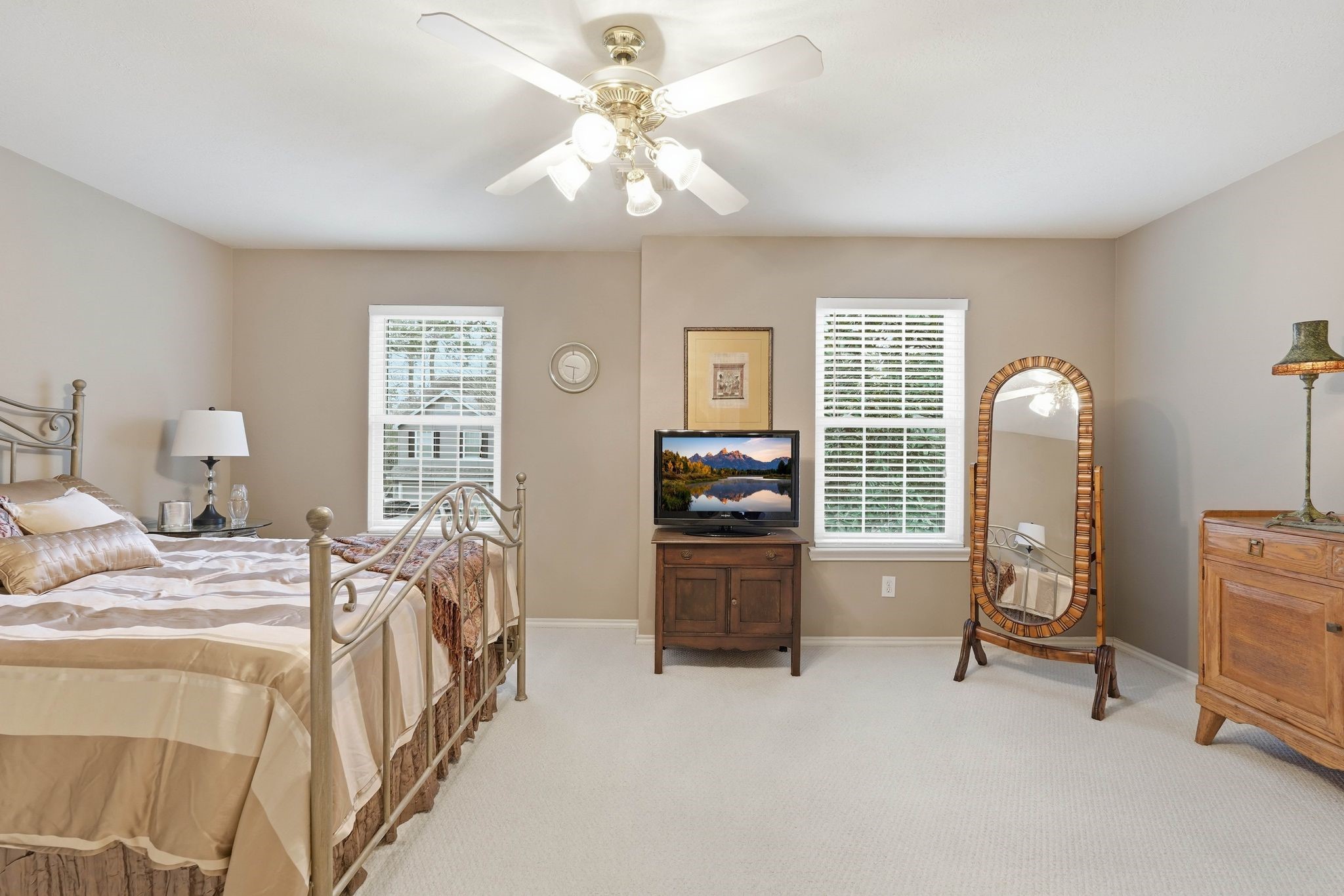51 Wineberry Place Spring, TX 77382 - Photo 28 of 45 a bedroom with a bed and a chandelier