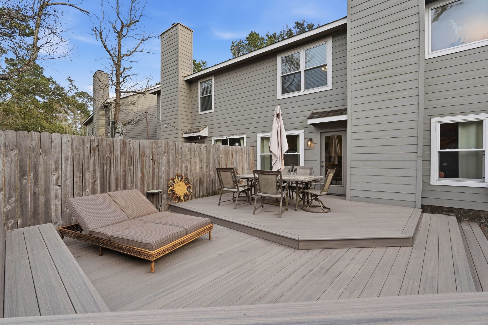 51 Wineberry Place Spring, TX 77382 - Photo 35 of 45 a view of a patio with table and chairs with wooden floor and fence