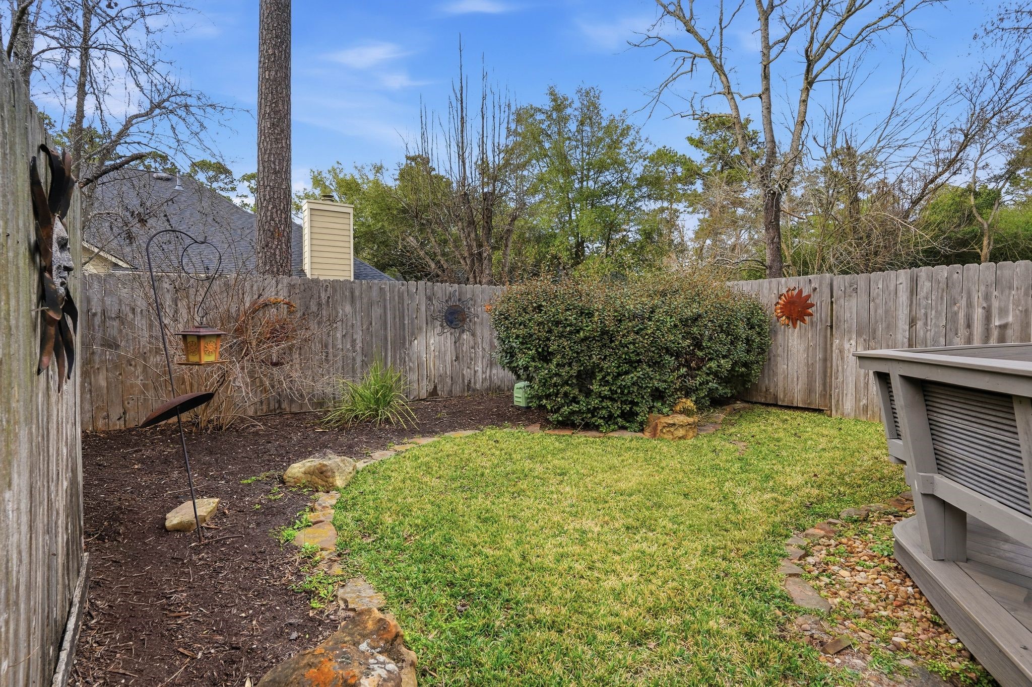 51 Wineberry Place Spring, TX 77382 - Photo 39 of 45 a view of backyard with potted plants and wooden fence