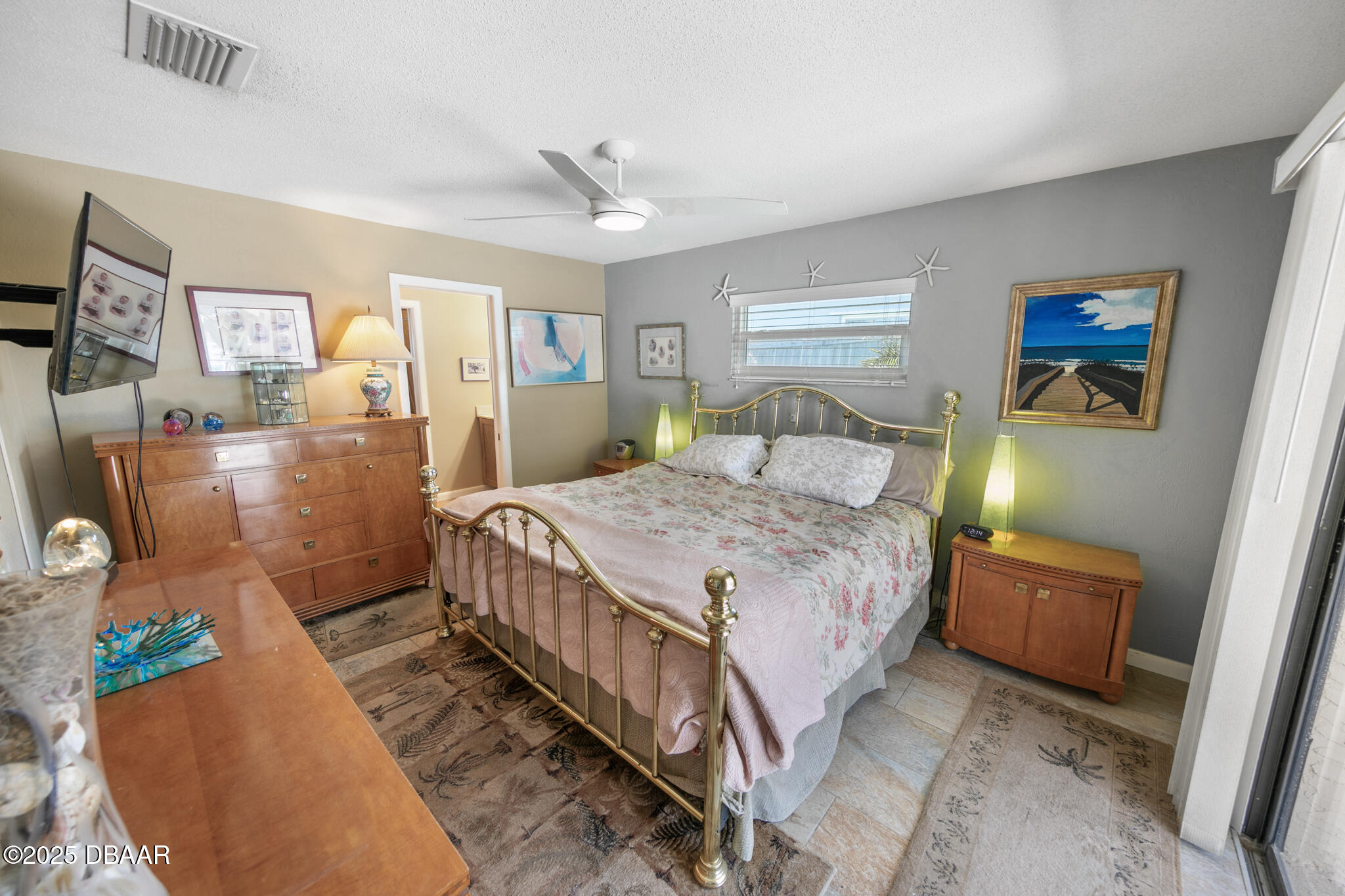 4350 Candlewood Lane Ponce Inlet, FL 32127 - Photo 23 of 60 a bedroom with a bed a dresser and painting on the wall