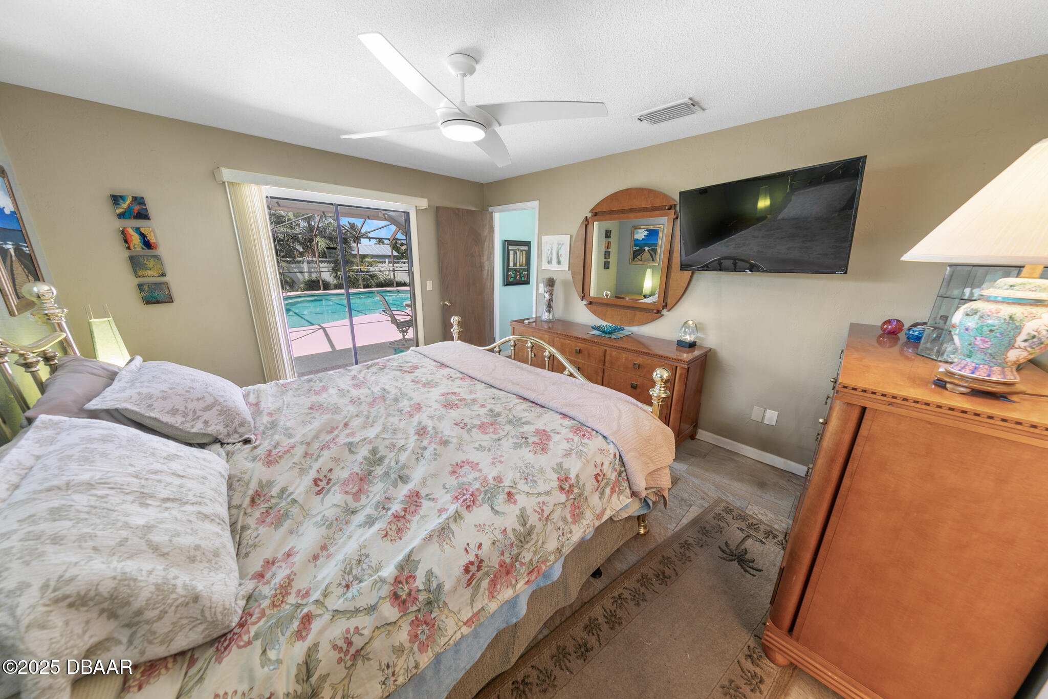 4350 Candlewood Lane Ponce Inlet, FL 32127 - Photo 25 of 60 a bedroom with a bed a window and dresser
