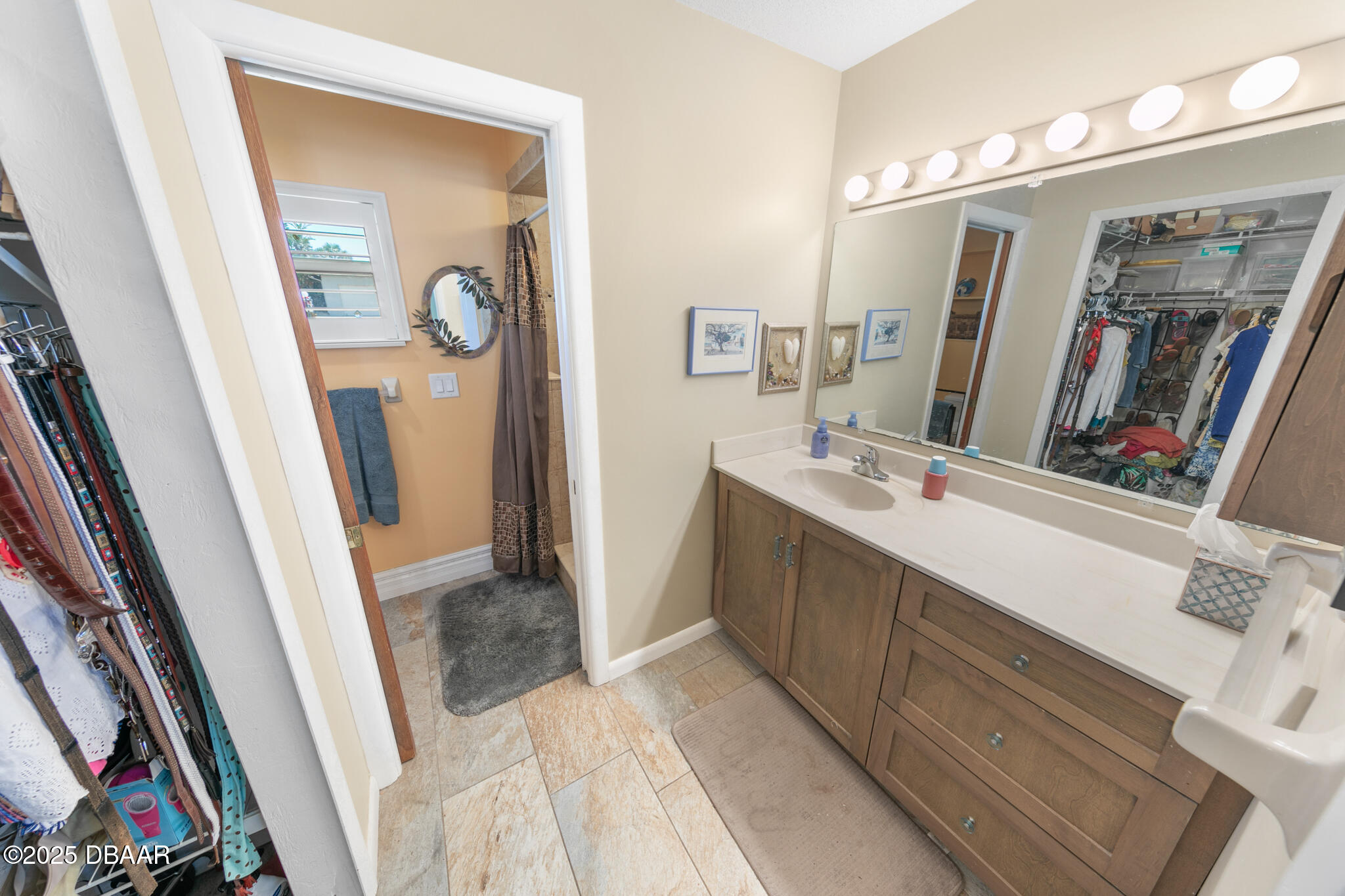 4350 Candlewood Lane Ponce Inlet, FL 32127 - Photo 26 of 60 a bathroom with a sink a mirror a vanity and a bathtub