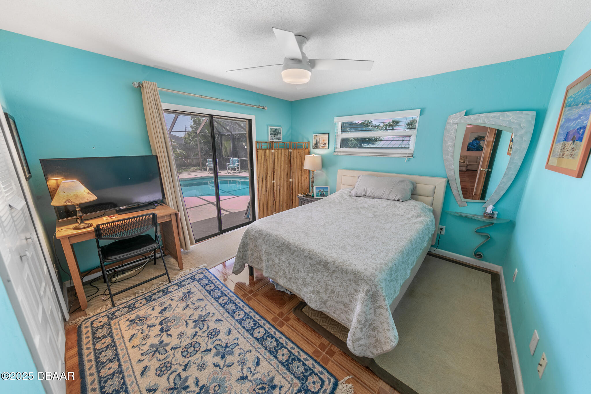 4350 Candlewood Lane Ponce Inlet, FL 32127 - Photo 29 of 60 a bedroom with a bed and a flat tv screen on the dresser