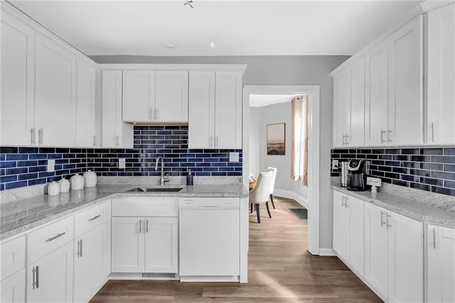a kitchen with stainless steel appliances a sink stove and cabinets