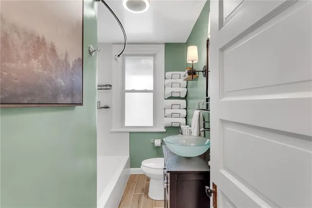 a bathroom with a toilet a sink and shower