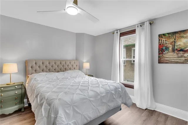 a large bed sitting in a bedroom next to a lamp