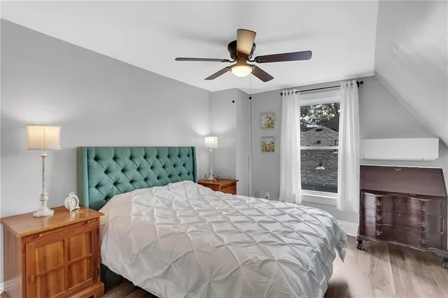 a bedroom with a large bed and a chandelier