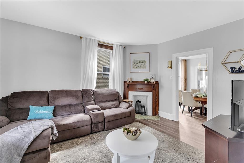 713 Clinton Place Pittsburgh, PA 15202 - Photo 7 of 31 a living room with furniture and a wooden floor