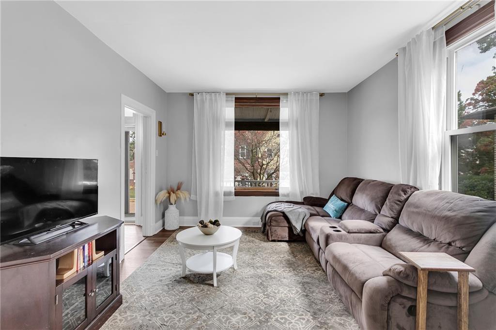 713 Clinton Place Pittsburgh, PA 15202 - Photo 8 of 31 a living room with furniture and a flat screen tv