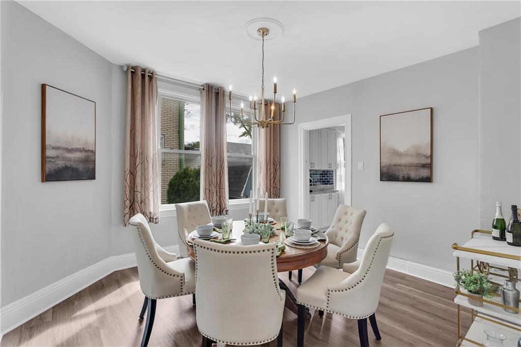 713 Clinton Place Pittsburgh, PA 15202 - Photo 9 of 31 a dining room with furniture a chandelier and wooden floor
