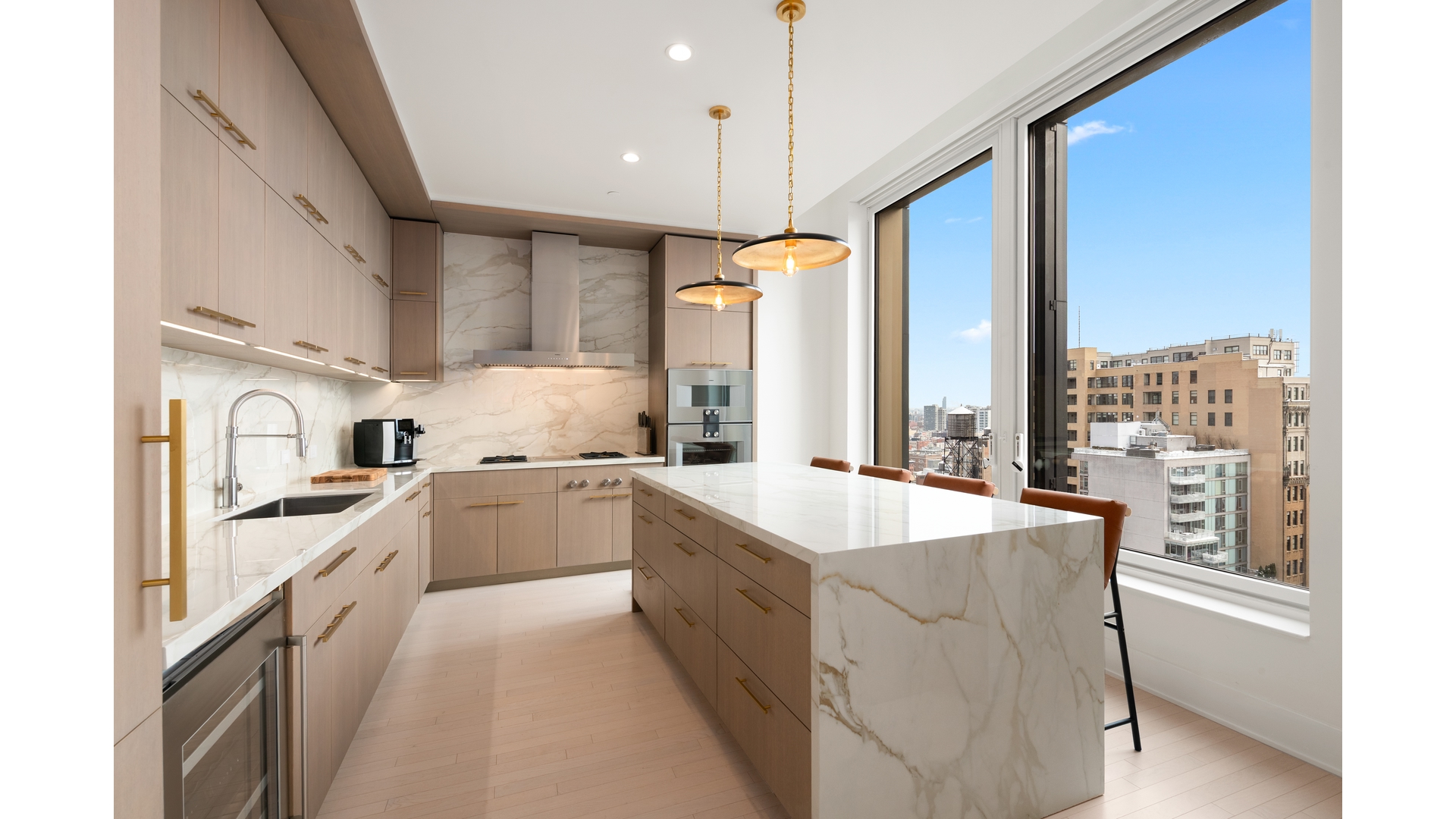 91 Leonard Street, Unit PH1 Manhattan, NY 10013 - Photo 3 of 25 a large kitchen with a large window and stainless steel appliances