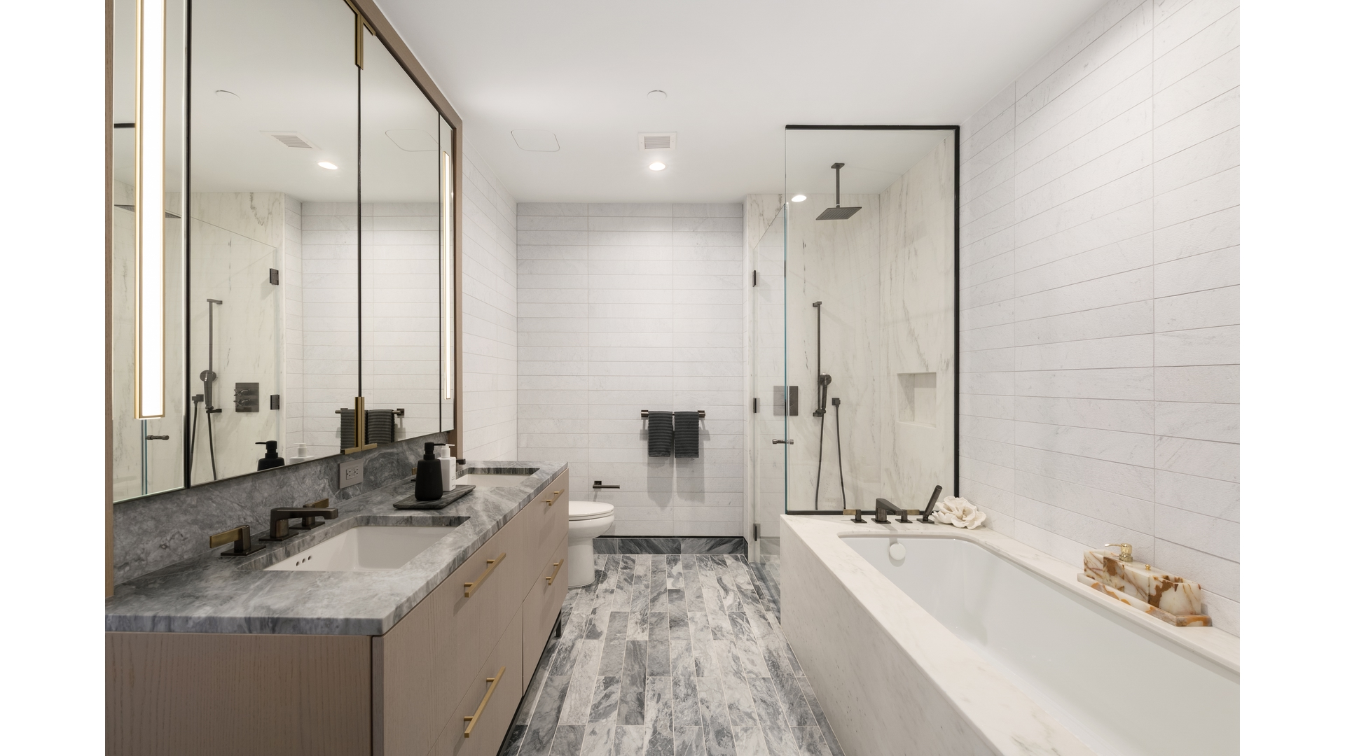 91 Leonard Street, Unit PH1 Manhattan, NY 10013 - Photo 6 of 25 a bathroom with a tub double sink and mirror