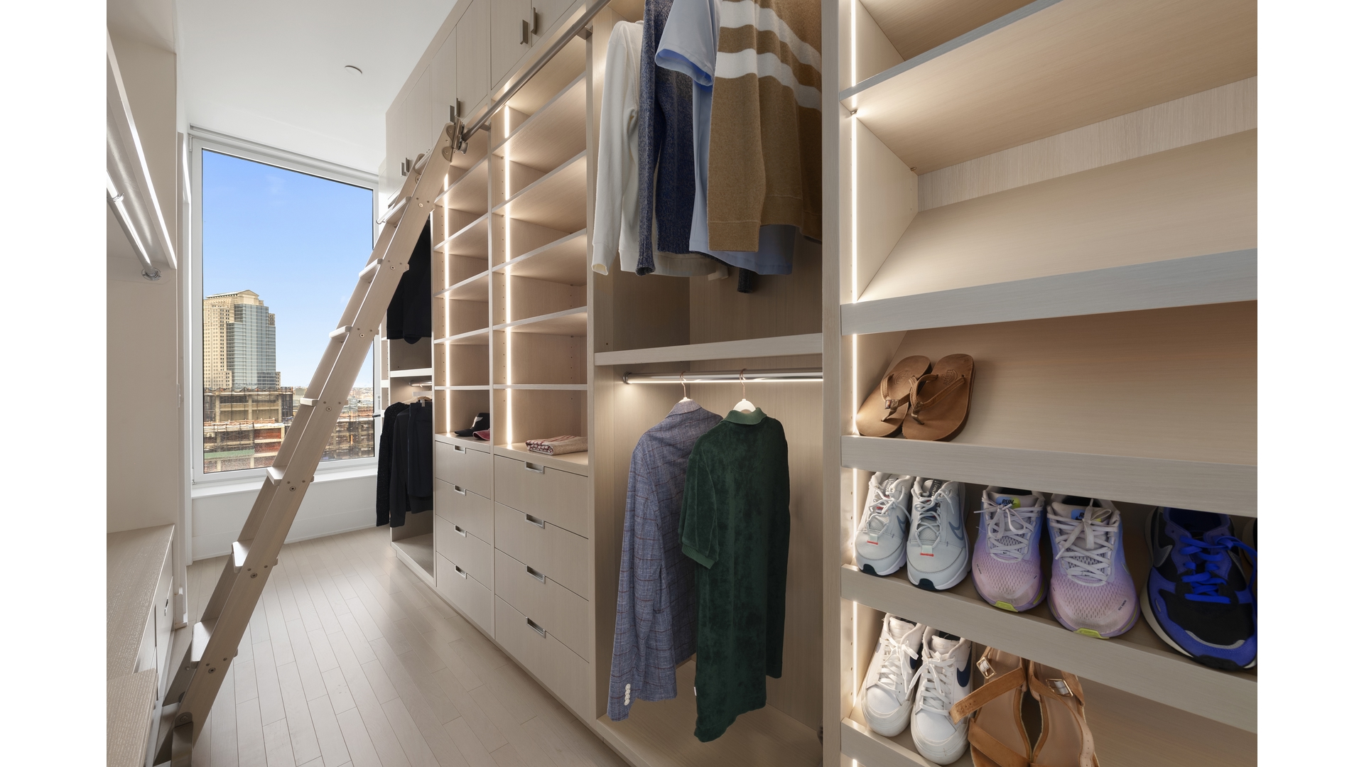 91 Leonard Street, Unit PH1 Manhattan, NY 10013 - Photo 7 of 25 a view of walk in closet with clothes and shoes