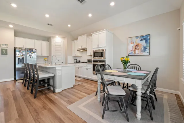 a view of a dining room with furniture and wooden floor