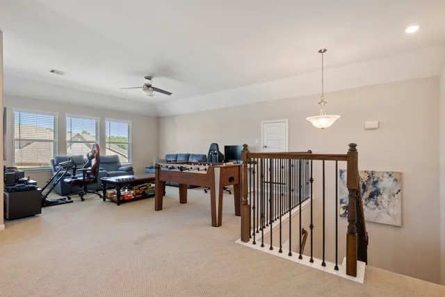 a living room with furniture gym equipment and a large window