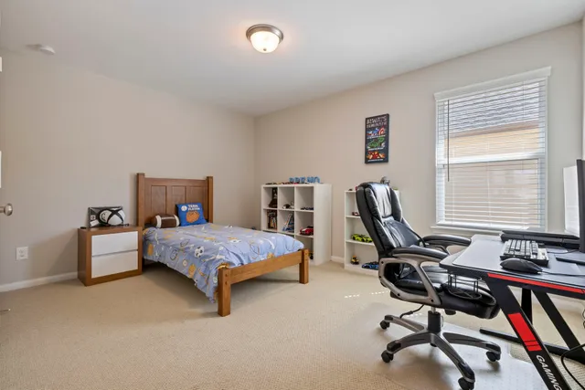 a bedroom with furniture and a window