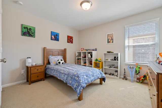 a bedroom with a bed and a desk