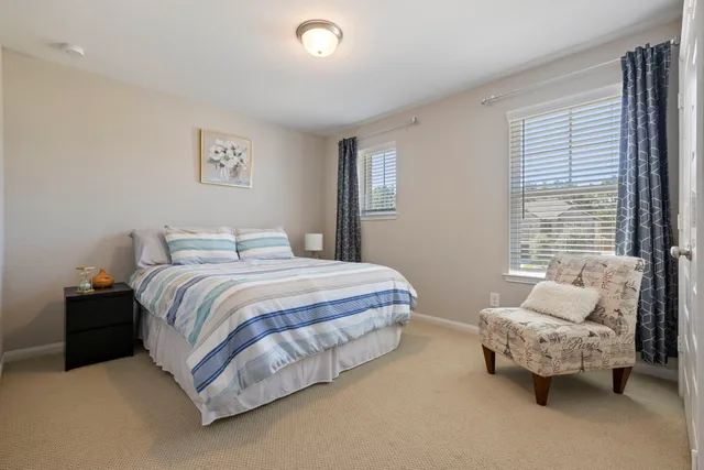 a spacious bedroom with a bed and a couch