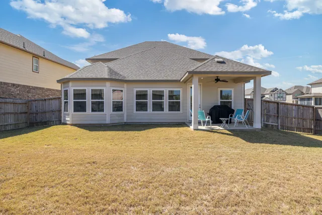 a view of a house with a swimming pool and a yard
