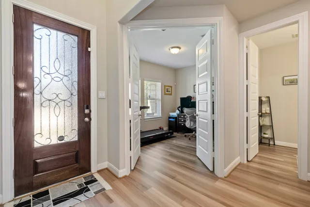 a view of a livingroom with wooden floor and a ceiling fan