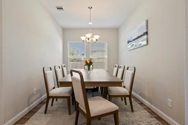 a view of a dining room with furniture and chandelier