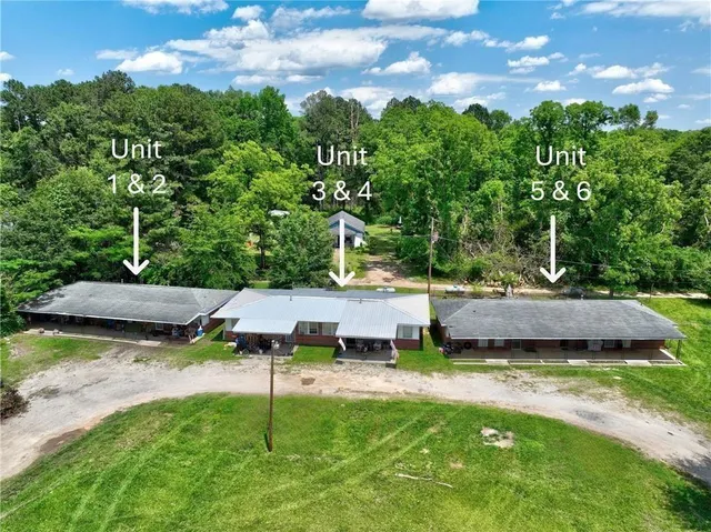 a view of a house with pool and a yard