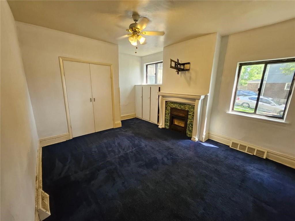 1907 Delaware Avenue, Unit 1 Pittsburgh, PA 15218 - Photo 4 of 12 a view of empty room with fireplace and wooden floor
