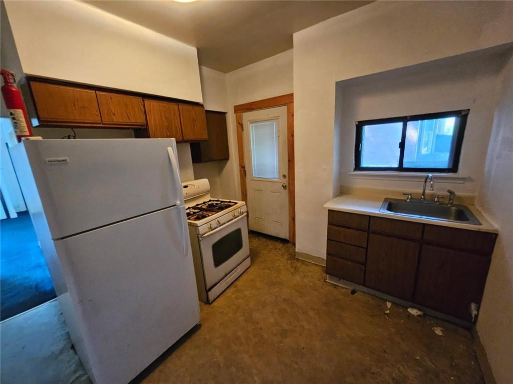 1907 Delaware Avenue, Unit 1 Pittsburgh, PA 15218 - Photo 7 of 12 a kitchen with sink refrigerator and stove