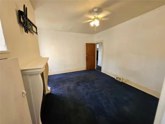 a view of an empty room with a bathroom