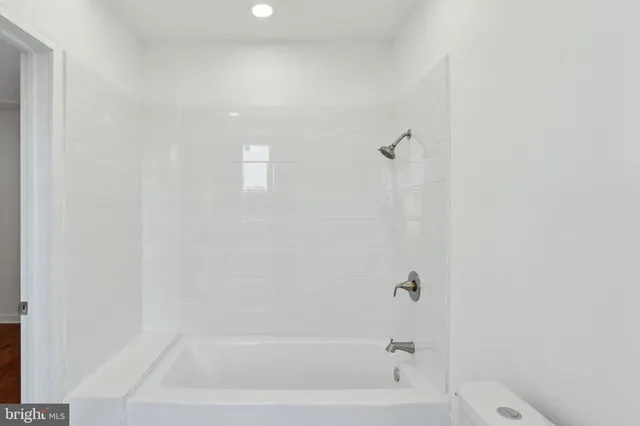 a white toilet sitting next to a bathroom sink