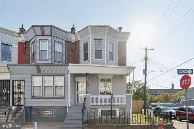 a view of a kitchen with wooden floor and stairs