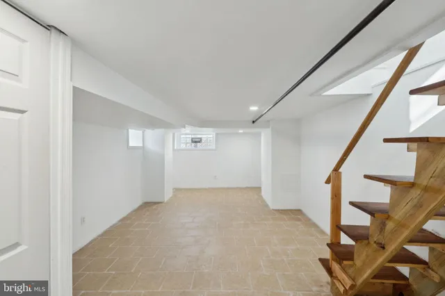 an empty room with white walls and tiles