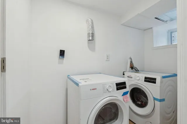 a bathroom with a sink mirror and shower