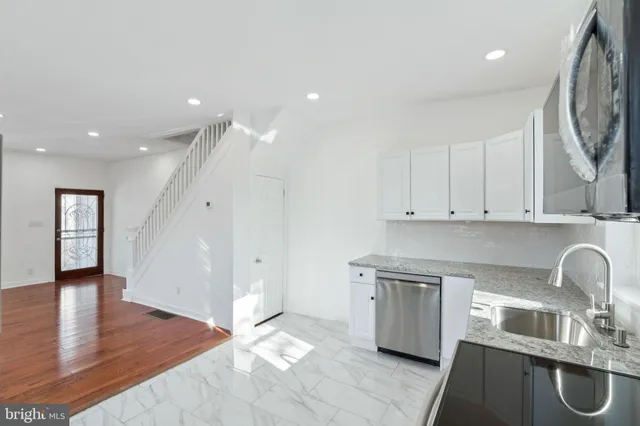 a kitchen with a refrigerator stove and sink