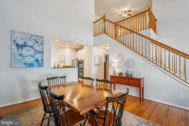 a kitchen with a refrigerator and a wooden floor