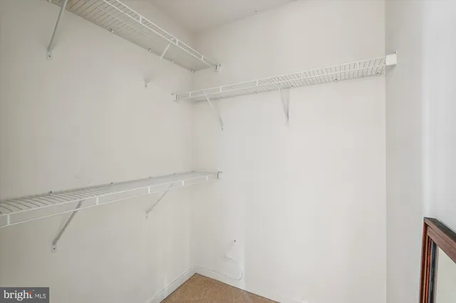 a street sign that is sitting on a brick wall