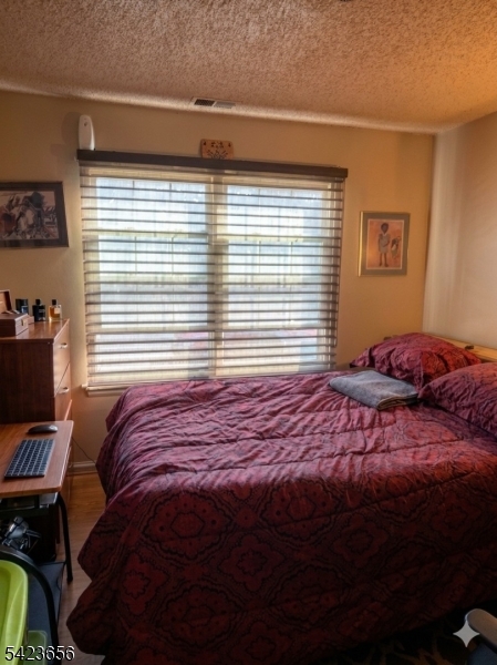 28 Rutgers Drive Newark, NJ 07103 - Photo 11 of 22 a bed sitting in a bedroom next to a window and a chair