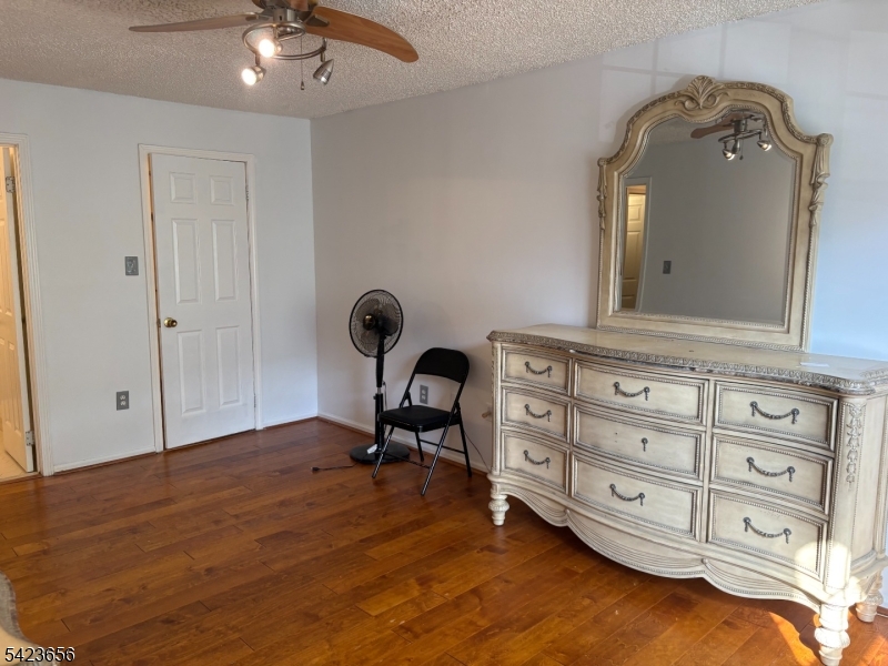 28 Rutgers Drive Newark, NJ 07103 - Photo 15 of 22 a view of a livingroom with a dresser wooden floor and cabinet