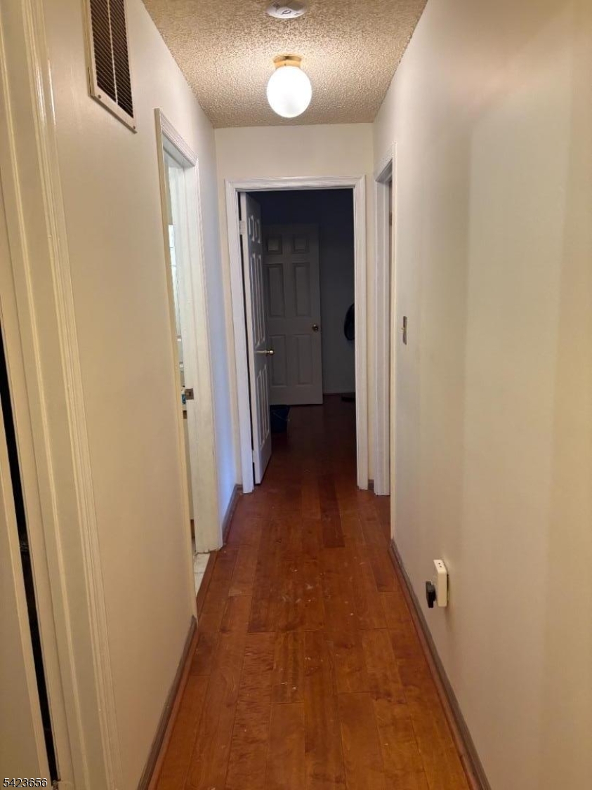 28 Rutgers Drive Newark, NJ 07103 - Photo 17 of 22 a view of a hallway with wooden floor and a bathroom