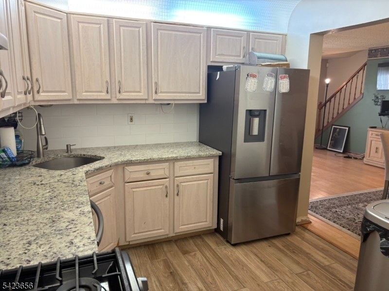 28 Rutgers Drive Newark, NJ 07103 - Photo 8 of 22 a kitchen with stainless steel appliances granite countertop a refrigerator sink and cabinets