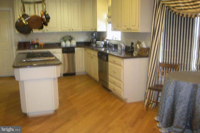 1310 Merrie Ridge Road McLean, VA 22101 - Photo 8 of 30 a kitchen with a sink a stove and cabinets
