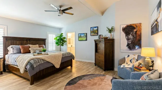 a bedroom with bed and wooden floor