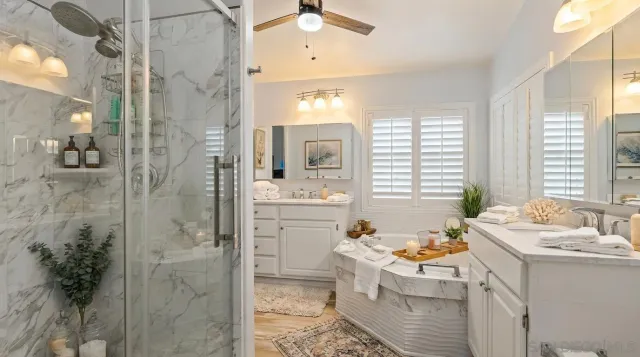 a bathroom with a tub sink and mirror