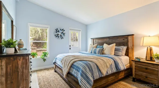 a bedroom with a large bed and a potted plant