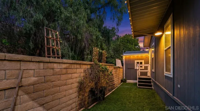 a view of a balcony with wooden floor and potted plants